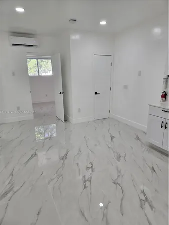 a white toilet sitting next to a sink and a mirror