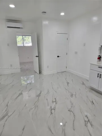 a white toilet sitting next to a sink and a mirror