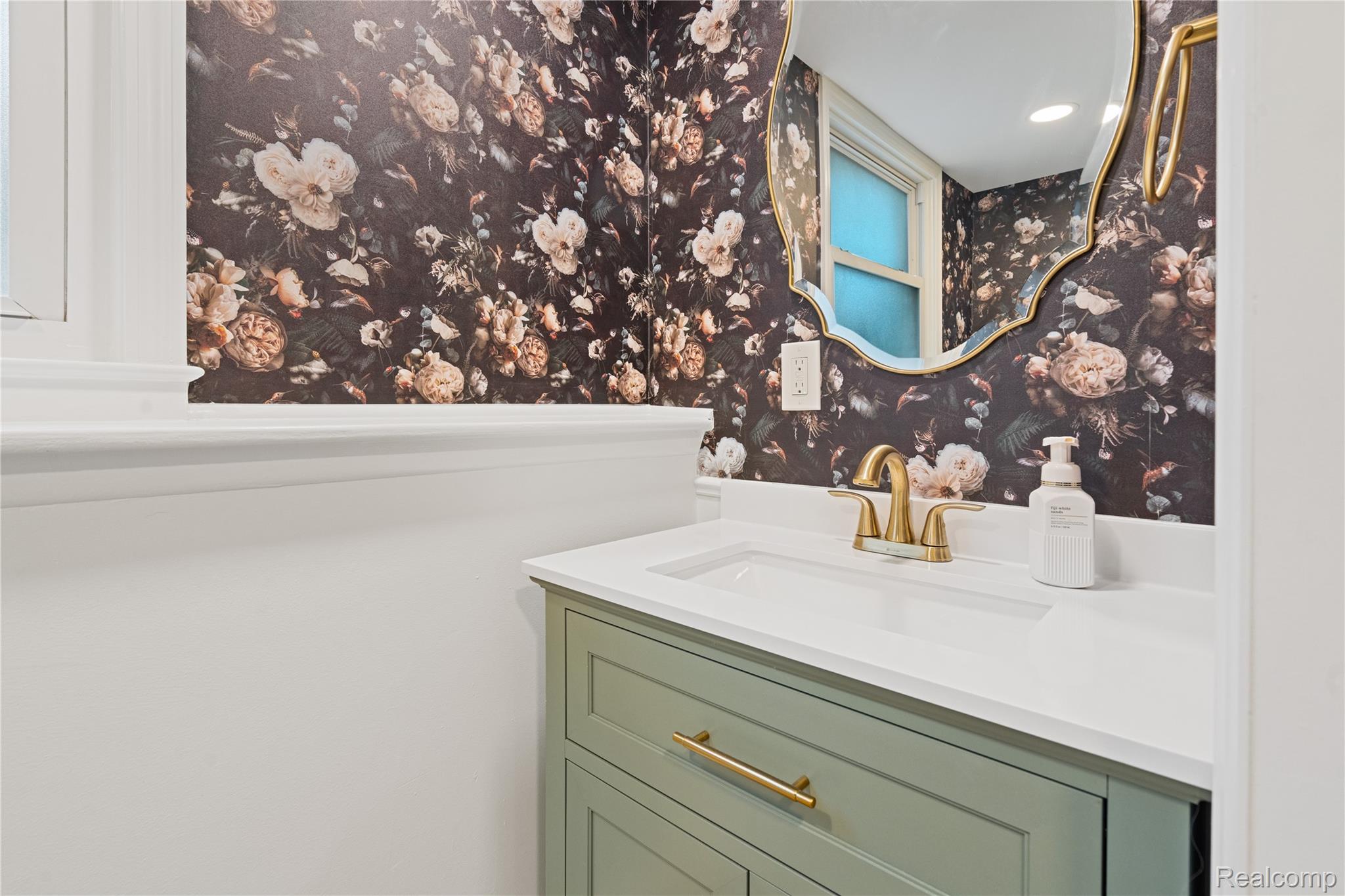 8240 Hampton Road Grosse Ile, MI 48138 - Photo 25 of 33 Vanity with light green cabinetry, gold-finish hardware, and a white countertop