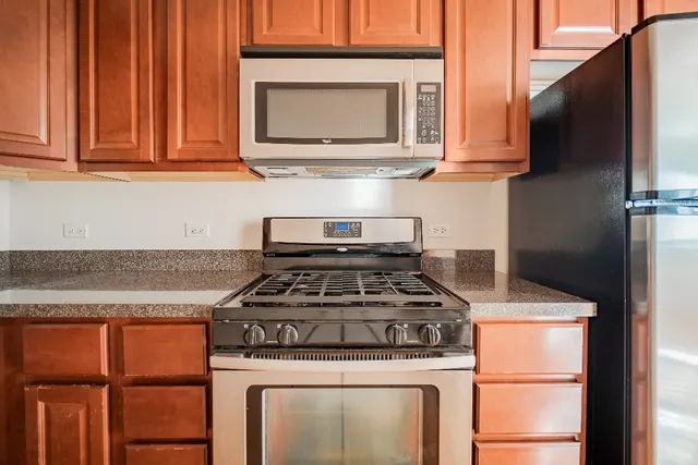 a stove top oven sitting inside of a kitchen