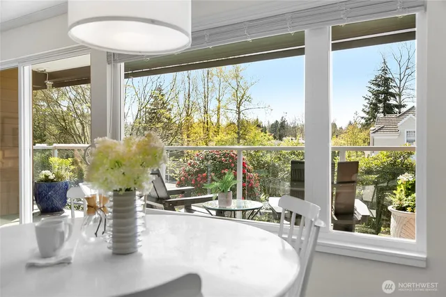 a living room with large windows and a table