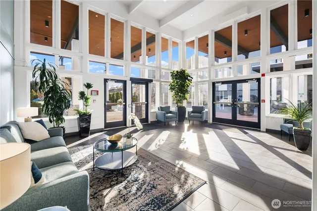 a view of a patio with couches table and chairs and potted plants