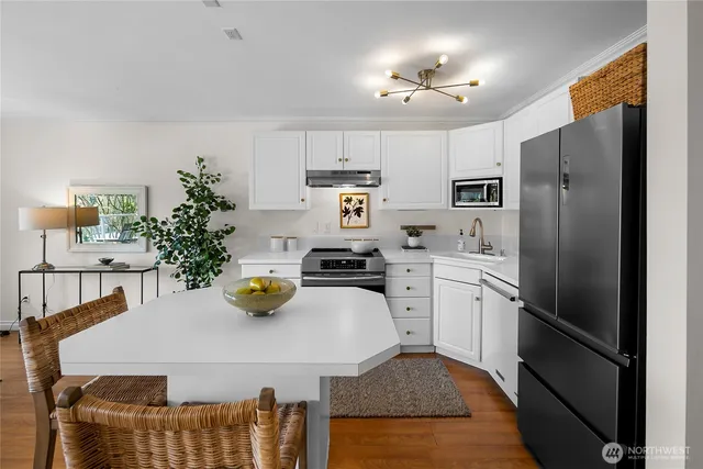 a kitchen with a refrigerator and microwave
