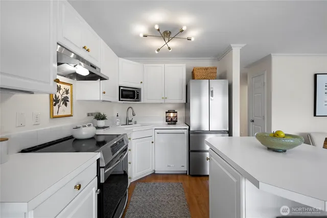 a kitchen with a sink appliances and cabinets