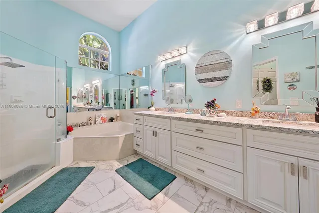 a spacious bathroom with double sink and a mirror