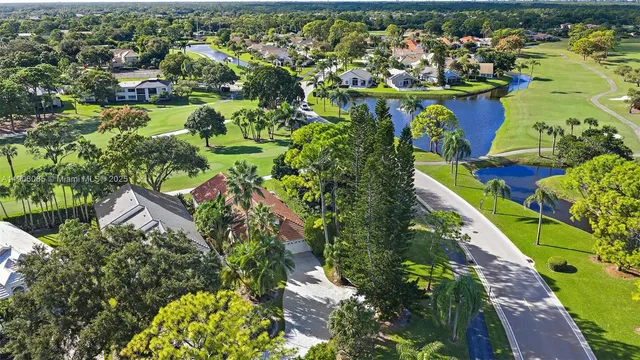 an aerial view of a houses with a lake view
