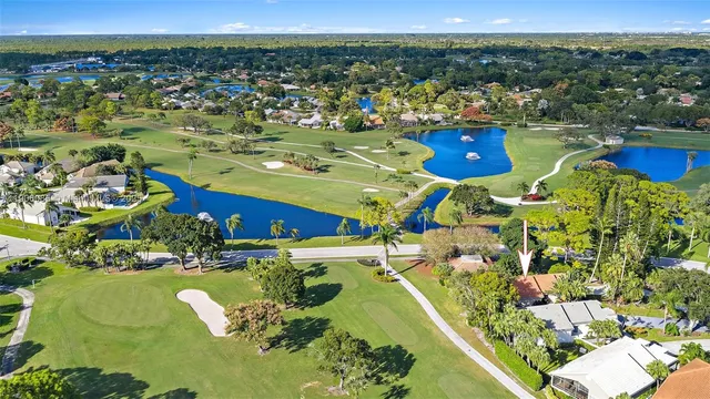 an aerial view of a house with a yard and garden