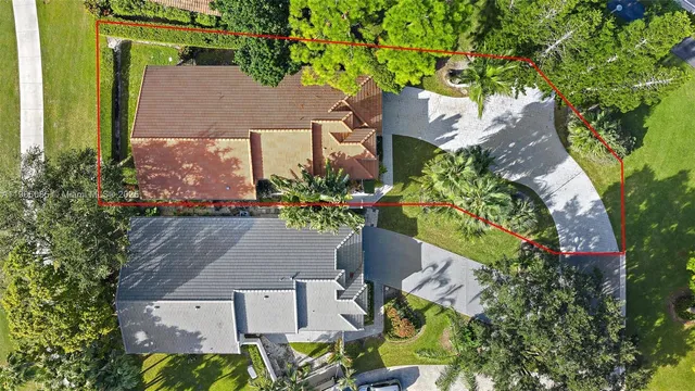 an aerial view of a house with a swimming pool yard and outdoor seating