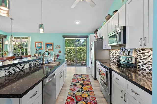 a kitchen with a sink stove and microwave