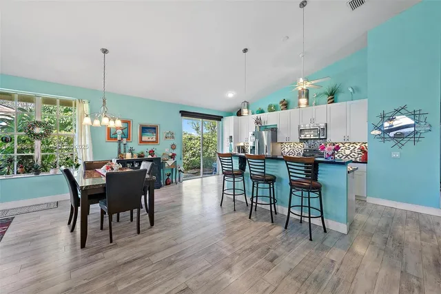 a dining room with furniture and wooden floor