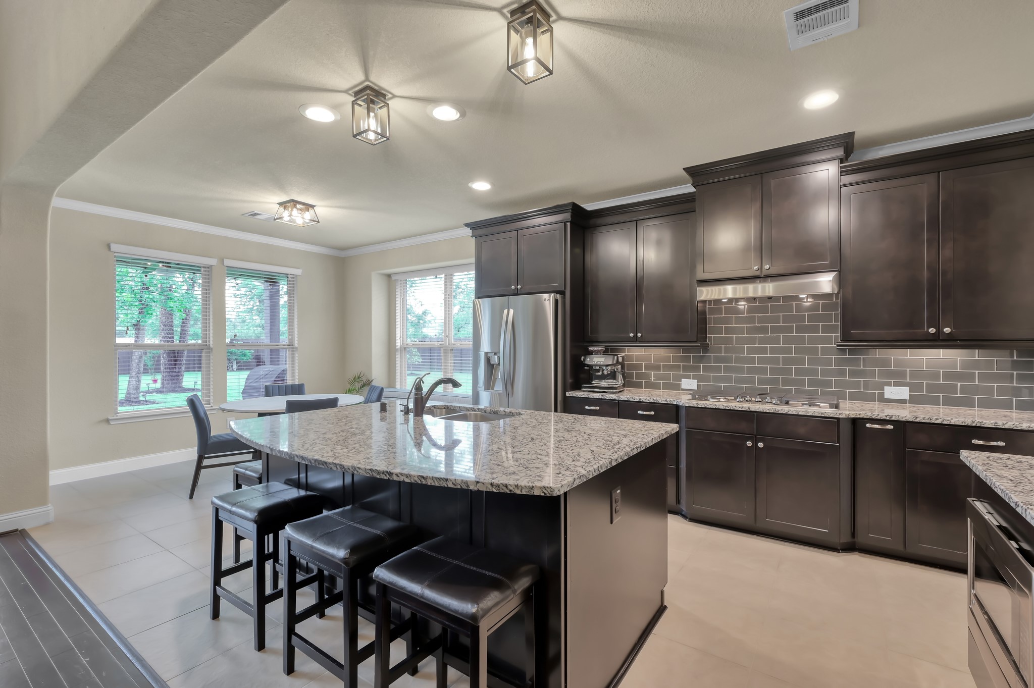23 Rancher's Trail Tomball, TX 77375 - Photo 13 of 40 Discover a spacious, inviting kitchen with a generous countertop perfect for entertaining, comfortably accommodating three to four stools for lively gatherings.