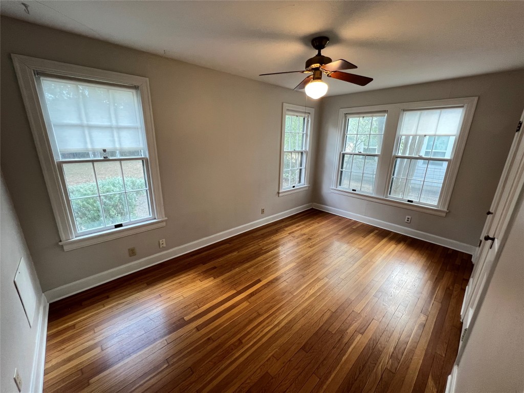 3009 French Place Austin, TX 78722 - Photo 17 of 27 a view of an empty room with wooden floor and a window