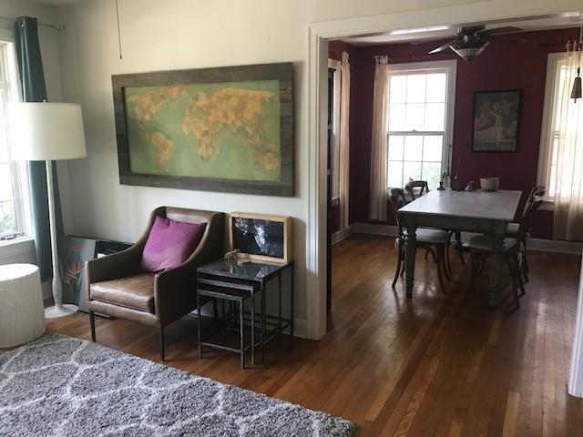3009 French Place Austin, TX 78722 - Photo 3 of 27 a living room with furniture a wooden floor and a large window