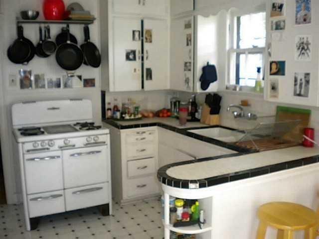 3009 French Place Austin, TX 78722 - Photo 4 of 27 a kitchen with a stove a sink and a stove next to a window