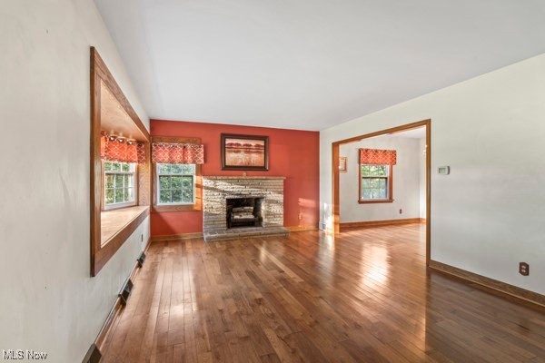 14413 Macklin Road New Springfield, OH 44443 - Photo 13 of 49 Unfurnished living room with dark wood-type flooring and a stone fireplace