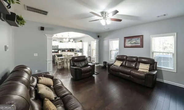 a living room with furniture a flat screen tv and a fireplace