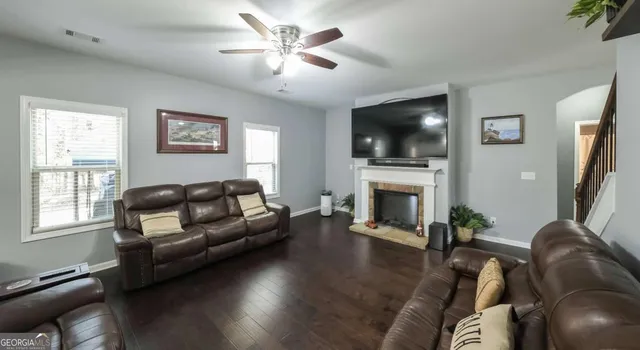 a living room with furniture and a fireplace