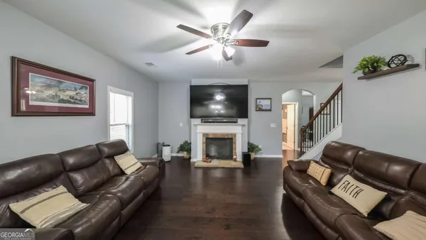 a living room with furniture a fireplace and a flat screen tv