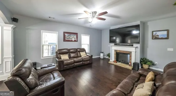 a living room with furniture and wooden floor