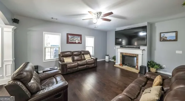 a living room with furniture and wooden floor