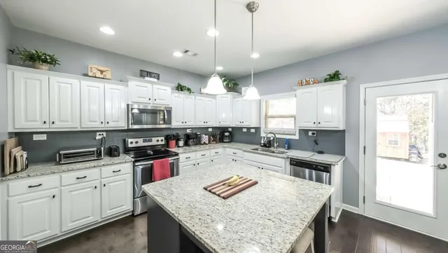 a kitchen with a sink stove and cabinets