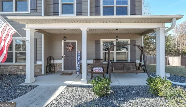 an aerial view of a house with swimming pool and porch