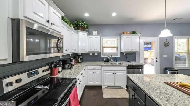 a store room with granite countertop lots of different kinds of food