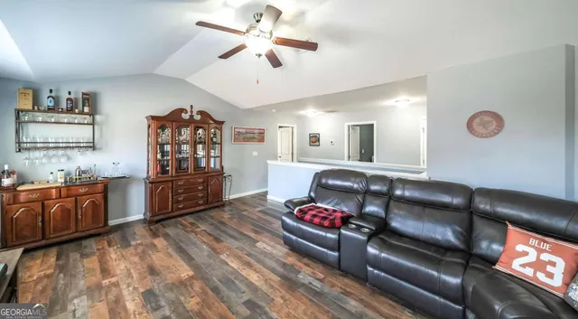 a living room with furniture and kitchen view