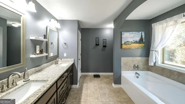 a bathroom with a granite countertop sink mirror and double