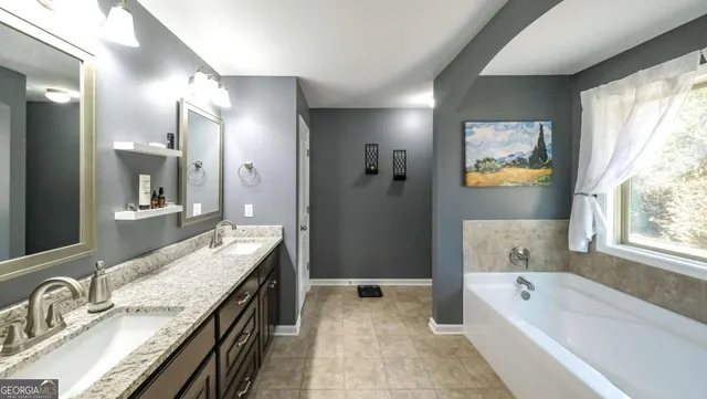 a bathroom with a granite countertop sink mirror and double