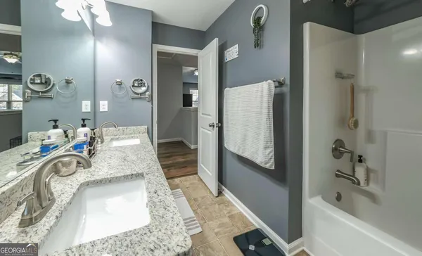 a room with a flat screen tv and dresser