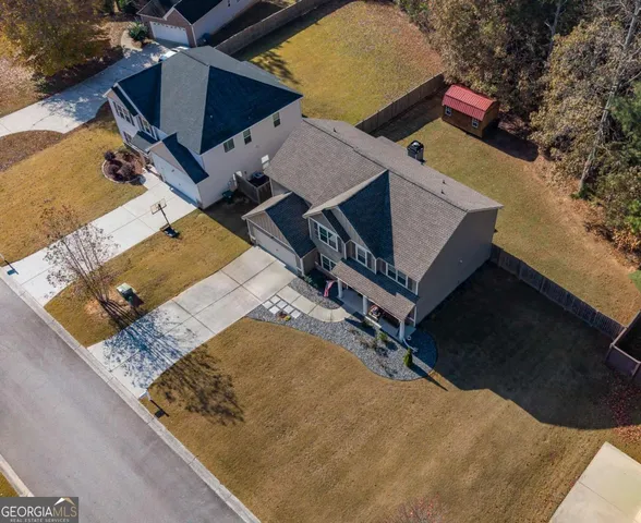 an aerial view of a house with outdoor space