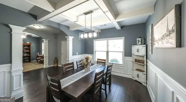 a view of a dining room with furniture and chandelier