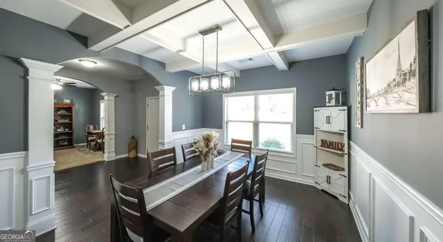 a view of a dining room with furniture and chandelier