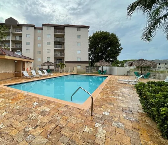 a view of a lake with a yard and a fountain