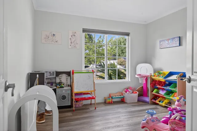 a bedroom with toys and a wooden floor