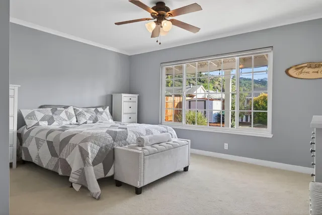 a bed sitting in a bedroom next to a window