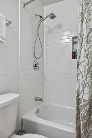 a bathroom with a bathtub and a toilet