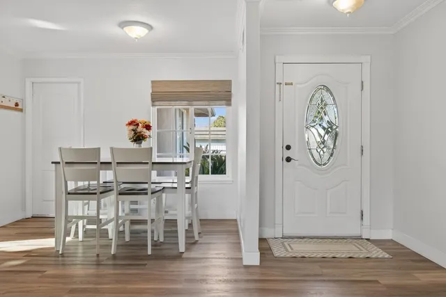 a view of a dining room with furniture and wooden floor