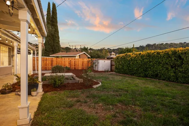 a view of a backyard with sitting area