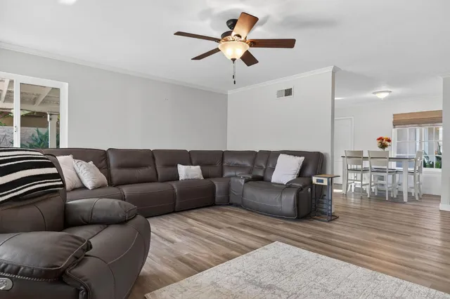 a living room with furniture and kitchen view