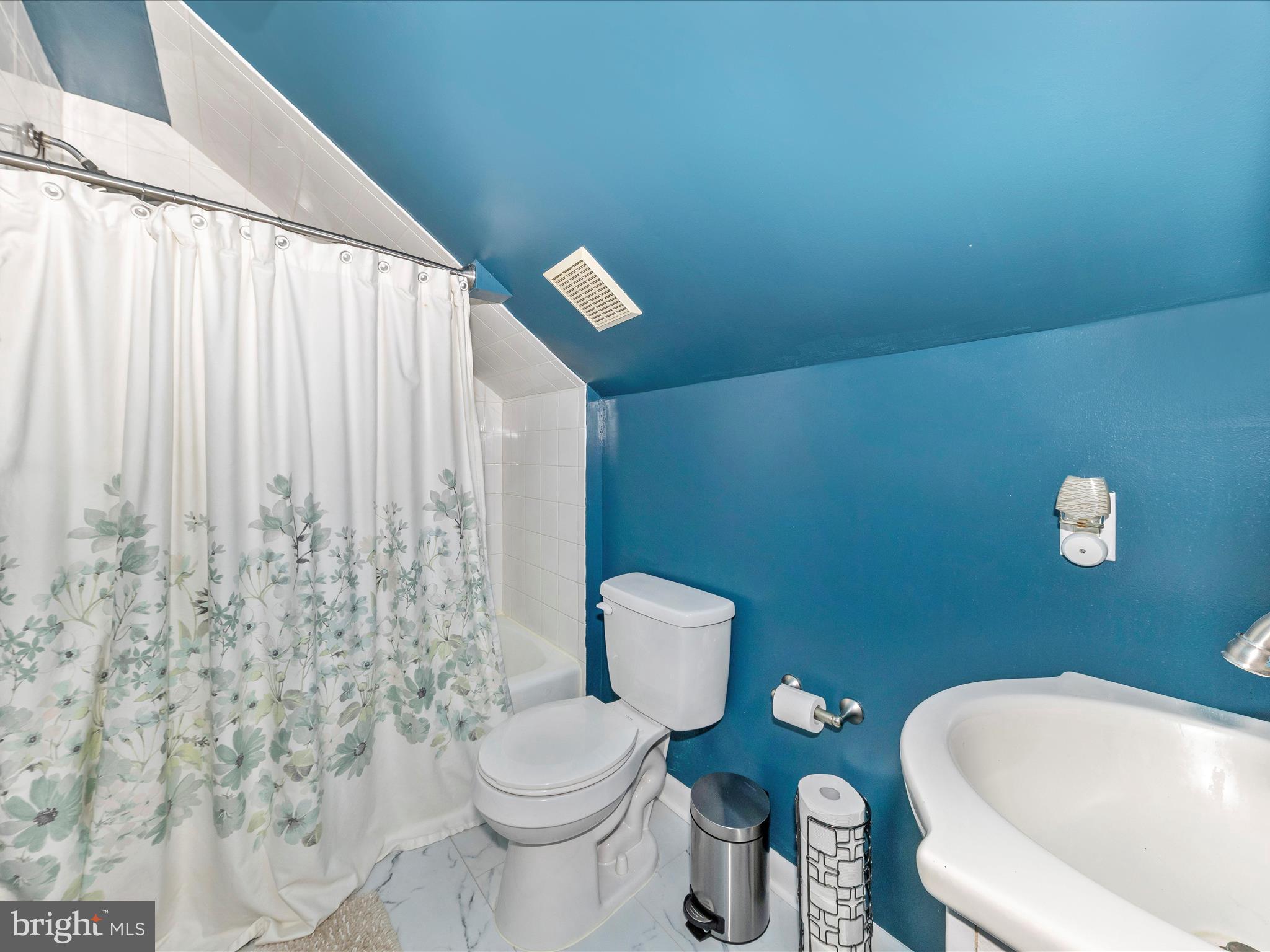 8829 Orndorff Road Thurmont, MD 21788 - Photo 32 of 46 a white toilet sitting next to a shower curtain