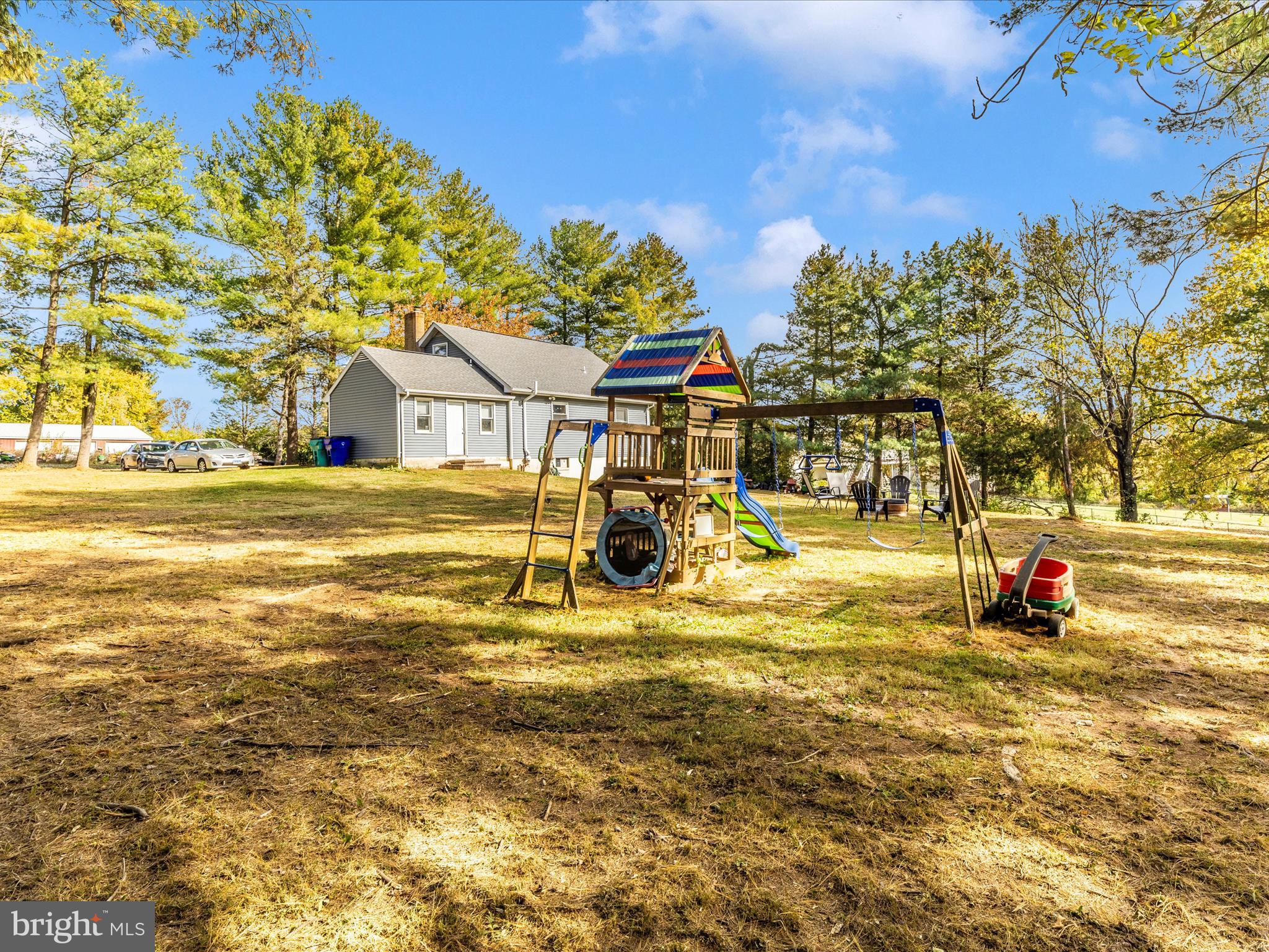 8829 Orndorff Road Thurmont, MD 21788 - Photo 42 of 46 a view of a swimming pool with a lawn chairs under an umbrella