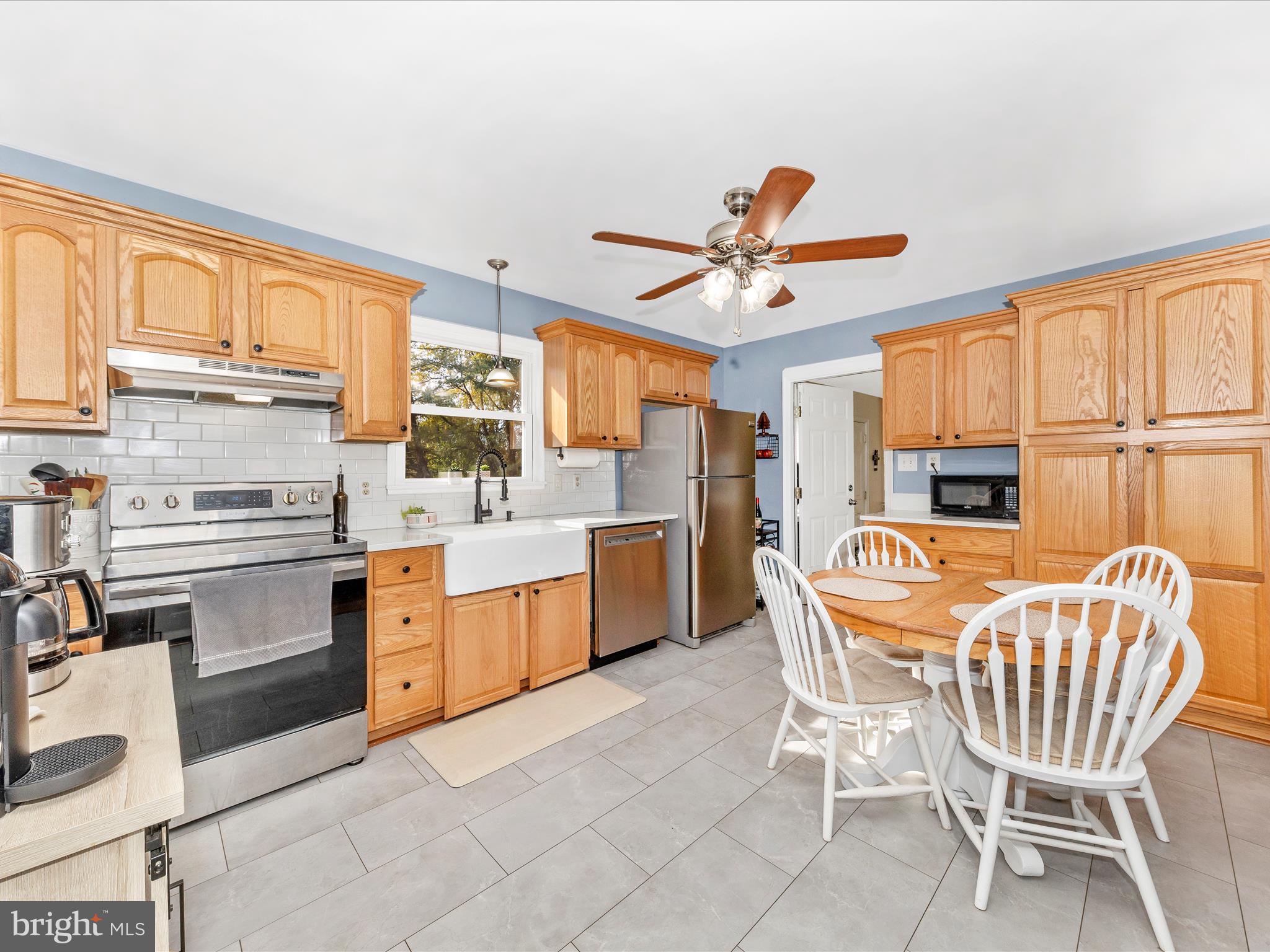 8829 Orndorff Road Thurmont, MD 21788 - Photo 8 of 46 a kitchen with stainless steel appliances a stove a sink cabinets and a dining table