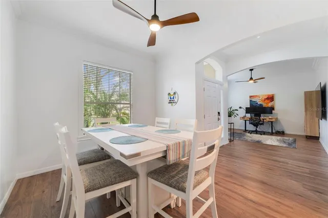 a view of a dining room with furniture and wooden floor