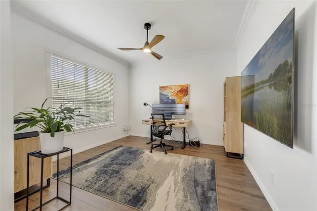 a view of a workspace with furniture and a window