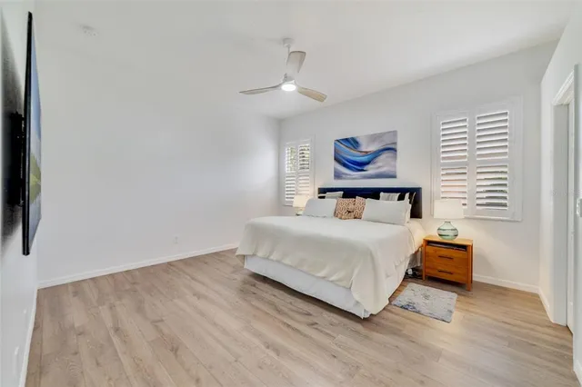 a bedroom with a bed and a painting on the wall