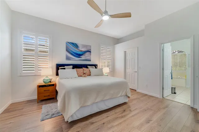 a bedroom with a bed and a painting on the wall