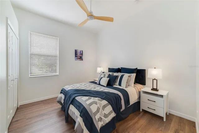 a bed sitting in a bedroom next to a window