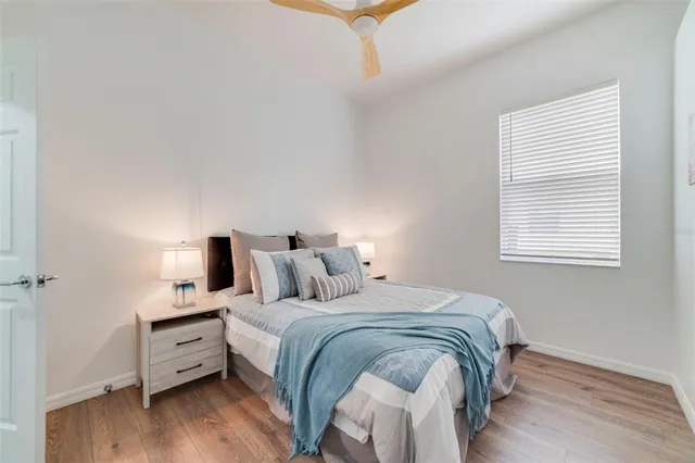 a bed room with a bed and a night stand